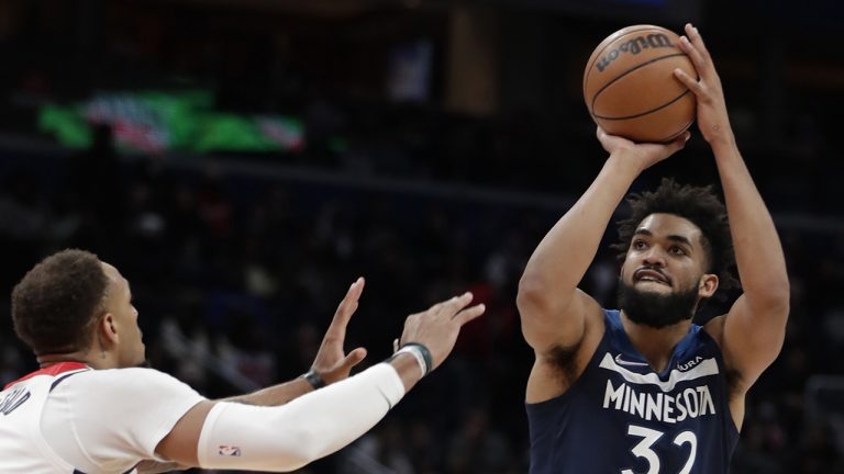 Minnesota Timberwolves' Karl-Anthony Towns (32) shoots as Washington Wizards' Daniel Gafford defends. (Luis M. Alvarez/AP)
