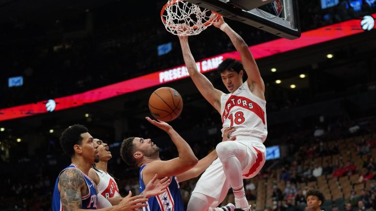 Toronto Raptors forward Yuta Watanabe (18) slam dunks over Philadelphia 76ers' Georges Niang, centre, battle for the ball during first half pre-season NBA basketball action in Toronto on Monday Oct. 4, 2021 (Nathan Denette/CP).