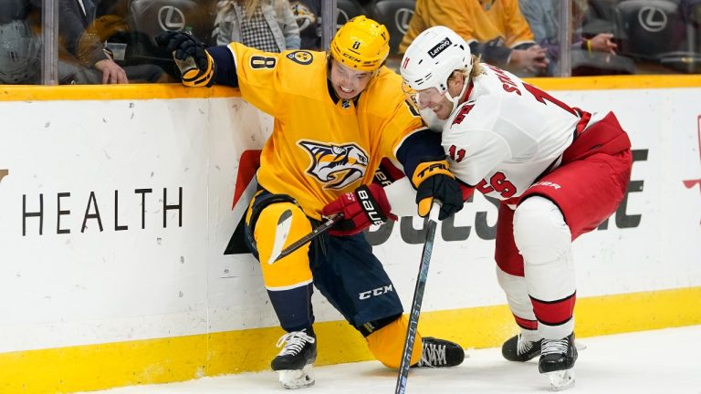 Nashville Predators center Cody Glass (8) and Carolina Hurricanes center Jordan Staal (11) battle in the second period of an NHL hockey game Saturday, Oct. 16, 2021, in Nashville, Tenn. (Mark Humphrey/AP Photo) 
