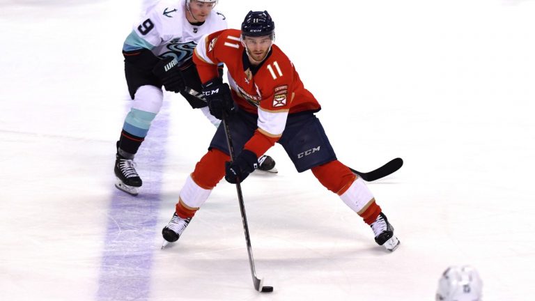 Florida Panthers left wing Jonathan Huberdeau (11) looks to pass as Seattle Kraken centre Ryan Donato (9) closes in during the second period of an NHL hockey game Saturday, Nov. 27, 2021, in Sunrise, Fla. (Jim Rassol/AP)