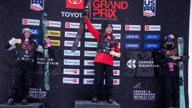 Eileen Gu, of China, stands on top of the podium next to Rachael Karker, left, of Canada, who took second, and Kelly Sildaru, of Estonia, who took third, following the halfpipe finals Friday, Dec. 10, 2021, during a U.S. Grand Prix freestyle skiing event at Copper Mountain, Colo. (Hugh Carey/AP)