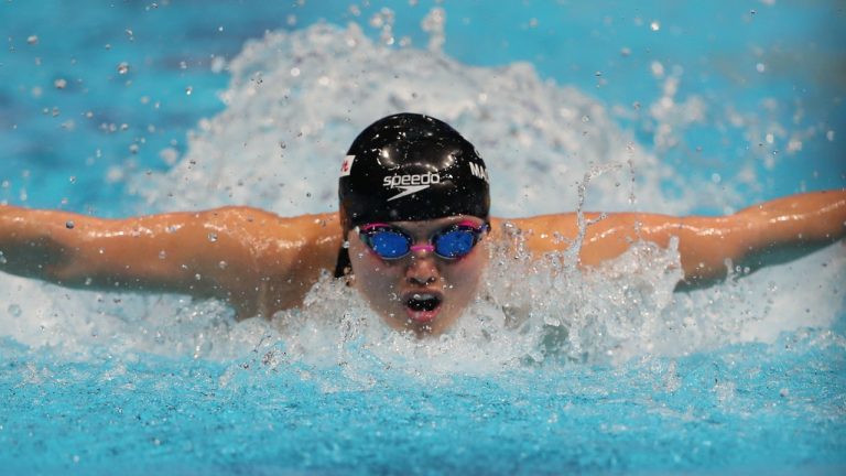 Canada's Maggie Mac Neil in action to win the 100 metres butterfly during World Swimming Championships in Abu Dhabi, United Arab Emirates, Tuesday, Dec. 21, 2021. (Kamran Jebreili/AP)