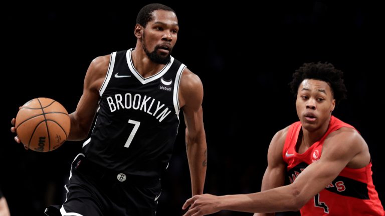 Brooklyn Nets forward Kevin Durant (7) drives past Toronto Raptors forward Scottie Barnes during the second half of an NBA basketball game. (Adam Hunger/AP)