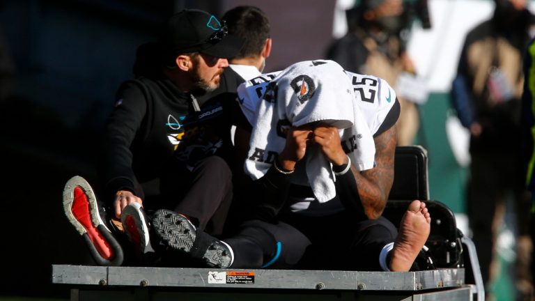 Jacksonville Jaguars running back James Robinson (25) is carted off the field during the first half of an NFL football game against the New York Jets Sunday, Dec. 26, 2021, in East Rutherford, N.J. (John Munson/AP)