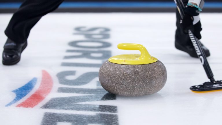 A curler sweeps a stone during the 2021 Masters in Oakville, Ont. (Anil Mungal)