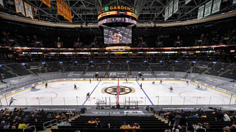 Hockey fans sit socially distanced in TD Garden before an NHL hockey game between the Boston Bruins and the New York Islanders, Thursday, March 25, 2021, in Boston. (Elise Amendola/AP) 