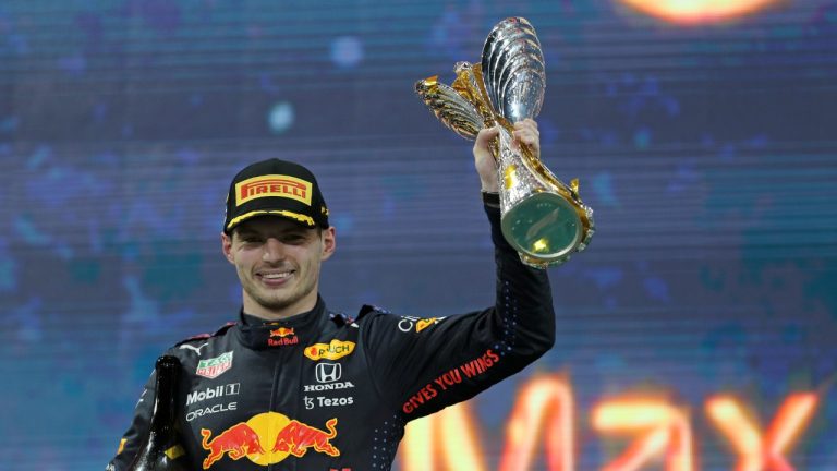 Red Bull driver Max Verstappen of the Netherlands celebrates on the podium after becoming F1 drivers world champion after winning the Formula One Abu Dhabi Grand Prix in Abu Dhabi, United Arab Emirates, Sunday, Dec. 12. 2021. (Kamran Jebreili/AP)