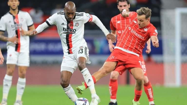 Atiba Hutchinson of Besiktas, left, and Antalyaspor's Deni Milosevic fight for the ball during Turkish Super Cup between Besiktas and Antalyaspor in Ar Rayan, Qatar, Wednesday, Jan. 5, 2022. (Hussein Sayed/AP) 