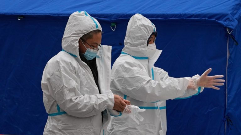 Medical workers prepare for testing at a mass coronavirus testing site in Beijing, Monday, Jan. 24, 2022. Chinese authorities have lifted a monthlong lockdown of Xi'an and its 13 million residents as infections subside ahead of the Winter Olympics. Meanwhile, the 2 million residents of one Beijing district are being tested following a series of cases in the capital. (Andy Wong/AP Photo) 
