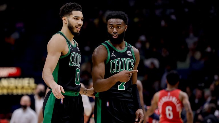 Boston Celtics forward Jayson Tatum (0) and guard Jaylen Brown (7) talk during a timeout in the fourth quarter of an NBA basketball game against the New Orleans Pelicans in New Orleans, Saturday, Jan. 29, 2022. (Derick Hingle/AP)