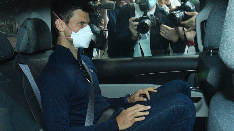 Serbian tennis player Novak Djokovic rides in car as he leaves a government detention facility before attending a court hearing at his lawyers office in Melbourne, Australia, Sunday, Jan. 16, 2022. (AP)