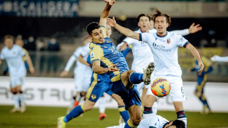 Verona's Davide Faraoni, left, and Bologna's Roberto Soriano, on the ground, during the Serie A soccer match between Hellas Verona and Bologna FC at L. Penzo stadium in Verona, Italy, Friday Jan. 21, 2022. (Claudio Martinelli/LaPresse via AP)