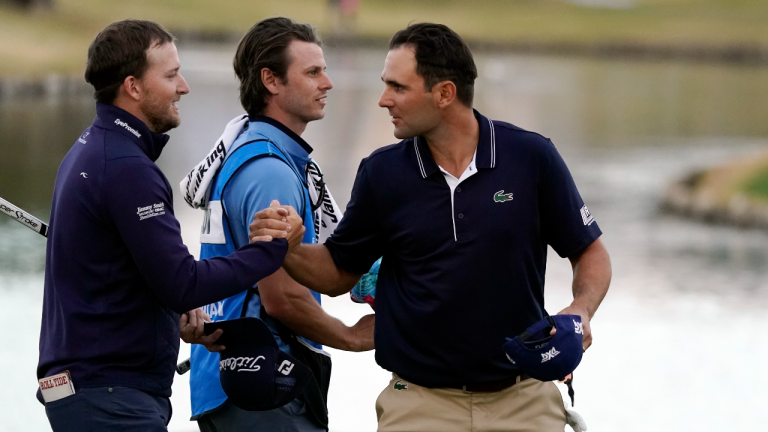 Lee Hodges, left, shakes hands with Paul Barjon on the ninth hole after they finished the third round of the American Express tournament on the Pete Dye Stadium Course at PGA West on Saturday, Jan. 22, 2022, in La Quinta, Calif. (AP)