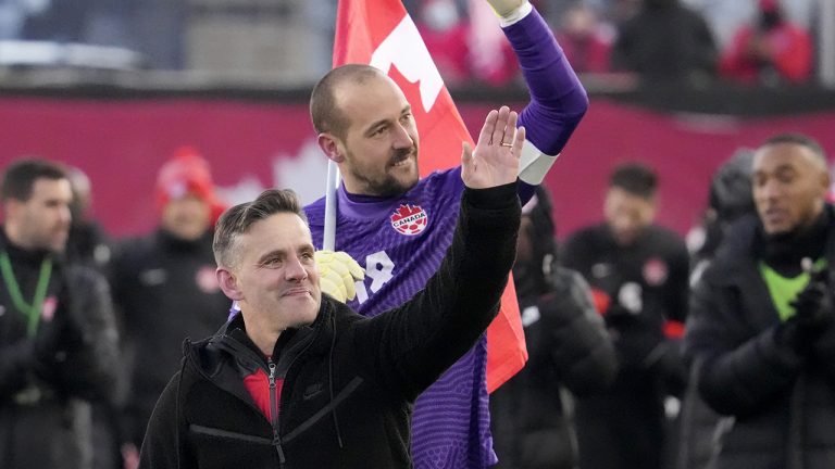 Canada's Milan Borjan (18) and head coach John Herdman celebrate the team's 2-0 victory following second half World Cup qualifying soccer action against the United States. (Frank Gunn/CP)