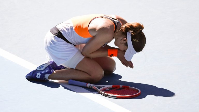 Alize Cornet of France reacts after defeating Simona Halep of Romania in their fourth round match at the Australian Open tennis championships in Melbourne, Australia, Monday, Jan. 24, 2022.(Andy Brownbill/AP Photo)