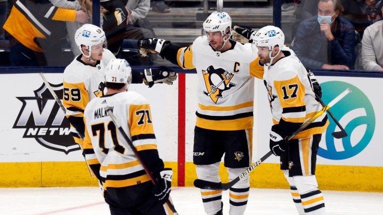 Pittsburgh Penguins forward Jake Guentzel (59), forward Evgeni Malkin (71), forward Sidney Crosby (87) and forward Bryan Rust (17) celebrate Crosby's second goal of the night against the Columbus Blue Jackets, during the third period of an NHL hockey game in Columbus, Ohio, Friday, Jan. 21, 2022. The Penguins won 5-2. (Paul Vernon/AP)