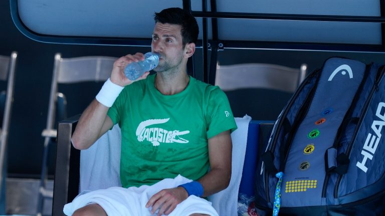 Defending men's champion Serbia's Novak Djokovic rests during a practice session on Margaret Court Arena ahead of the Australian Open tennis championship in Melbourne, Australia, Thursday, Jan. 13, 2022. (Mark Baker/AP Photo) 