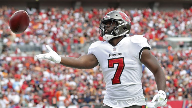 Tampa Bay Buccaneers running back Leonard Fournette (7) throws the ball to a fan after his touchdown run against the Chicago Bears during the first half of an NFL football game. (Mark LoMoglio/AP)