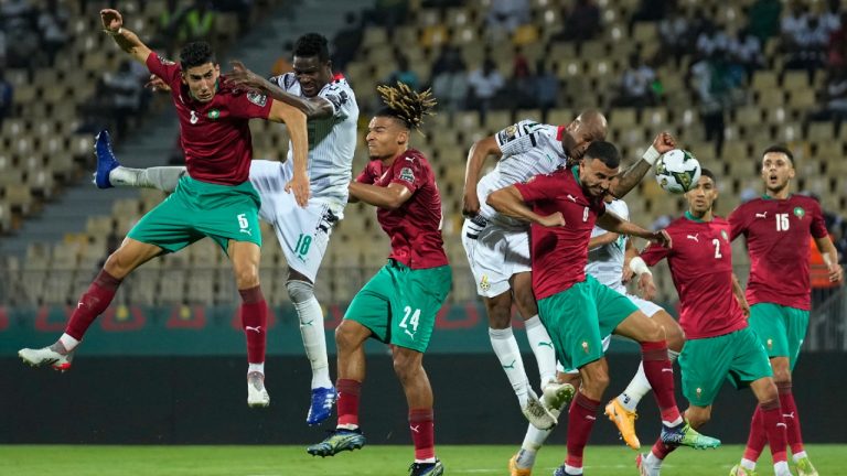 Ghana's captain Andre Ayew, center left, collides with Morocco's captain Romain Saiss, center right, during the African Cup of Nations 2022 group B soccer match between Morocco and Ghana at the Ahmadou Ahidjo stadium in Yaounde, Cameroon, Monday, Jan. 10, 2022. (Themba Hadebe/AP) 