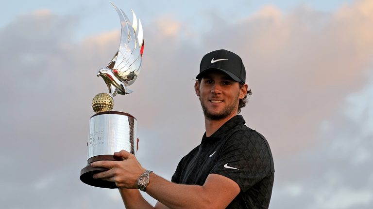 Thomas Pieters of Belgium holds the trophy after he won the Abu Dhabi Championship golf tournament at the Yas Links Golf Course, in Abu Dhabi, United Arab Emirates, Sunday, Jan. 23, 2022. (Kamran Jebreili/AP)