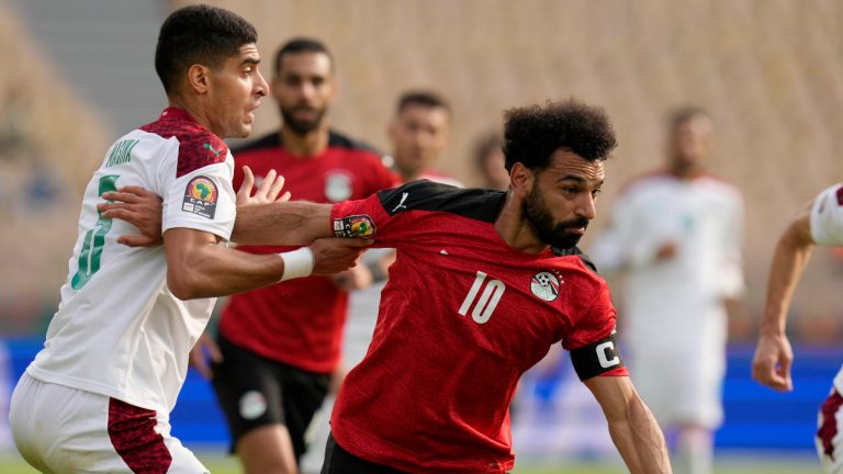 Egypt's Mohamed Salah, right, is challenged by Morocco's Adam Masina during the African Cup of Nations 2022 quarterfinal soccer match between Egypt and Morocco at the Ahmadou Ahidjo stadium in Yaounde, Cameroon, Sunday, Jan. 30, 2022. (Themba Hadebe/AP)