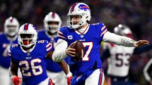 Buffalo Bills quarterback Josh Allen (17) runs the ball during the first half of an NFL wild-card playoff football game against the New England Patriots, Saturday, Jan. 15, 2022, in Orchard Park, N.Y. (Adrian Kraus/AP)