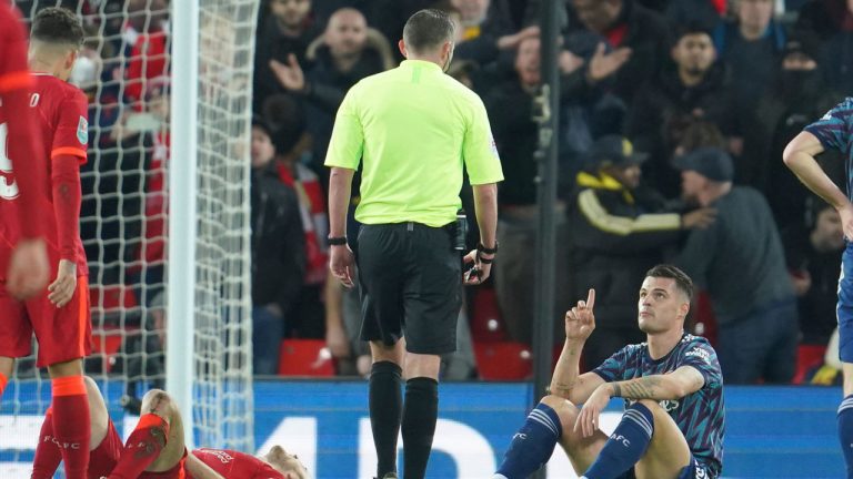 Arsenal's Granit Xhaka, left, speaks to the referee after seeing the red card during the EFL Cup semifinal, first leg soccer match between Liverpool and Arsenal at the Anfield Stadium. (Jon Super/AP) 
