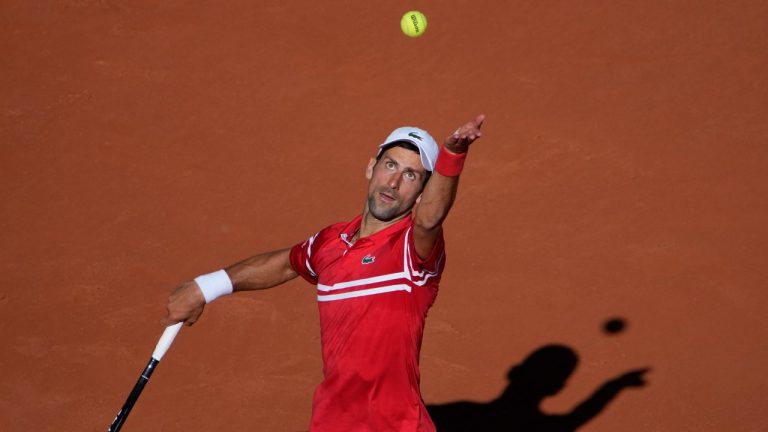 Serbia's Novak Djokovic serves to Stefanos Tsitsipas of Greece during their final match of the French Open tennis tournament at the Roland Garros stadium Sunday, June 13, 2021 in Paris. (Christophe Ena/AP)