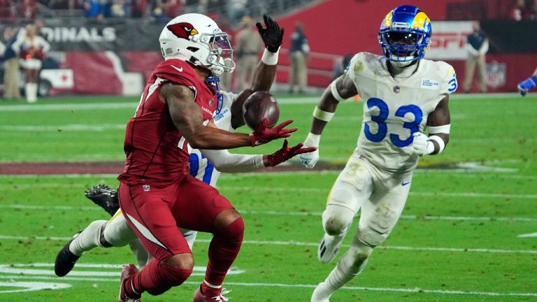Arizona Cardinals wide receiver Christian Kirk, left, makes a catch against Los Angeles Rams cornerback Darious Williams, back left, and Rams safety Nick Scott (33) during the first half of an NFL football game Monday, Dec. 13, 2021, in Glendale, Ariz. (Rick Scuteri/AP)