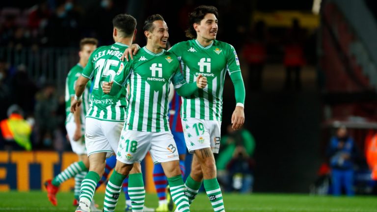 Betis' Andres Guardado and Hector Bellerin celebrate at the end of the Spanish La Liga soccer match between Barcelona and Real Betis at the Camp Nou stadium, in Barcelona, Spain, Saturday, Dec. 4, 2021. Betis won 1-0. (Joan Monfort/AP)