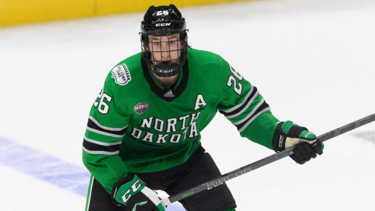 North Dakota defenceman Jake Sanderson plays against Penn State during an NCAA college hockey game on Saturday, Oct. 30, 2021, in Nashville, Tenn. USA Hockey and Hockey Canada are eyeing several college players to play at the Olympics after the NHL decided not to participate in Beijing. Sanderson has already agreed to play for the U.S. (John Amis/AP)