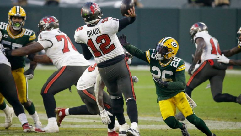 Green Bay Packers' Darnell Savage (26) puts pressure on Tampa Bay Buccaneers quarterback Tom Brady as he throws a pass intercepted by Green Bay Packers' Jaire Alexander during the second half of the NFC championship NFL football game in Green Bay, Wis., Sunday, Jan. 24, 2021. (Mike Roemer/AP)