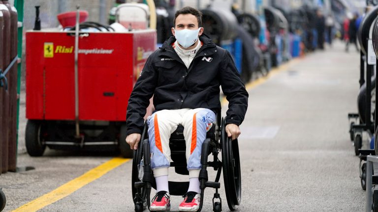 Robert Wickens makes his way to his pit stall during practice for the Rolex 24 hour auto race at Daytona International Speedway. (John Raoux/AP)