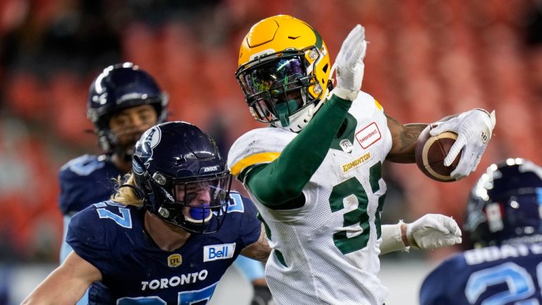 Edmonton Elks running back James Wilder Jr. (32) runs the ball past Toronto Argonauts defensive back Josh Hagerty (27) during second half CFL football action in Toronto, Tuesday, Nov. 16, 2021. (Nathan Denette/CP)