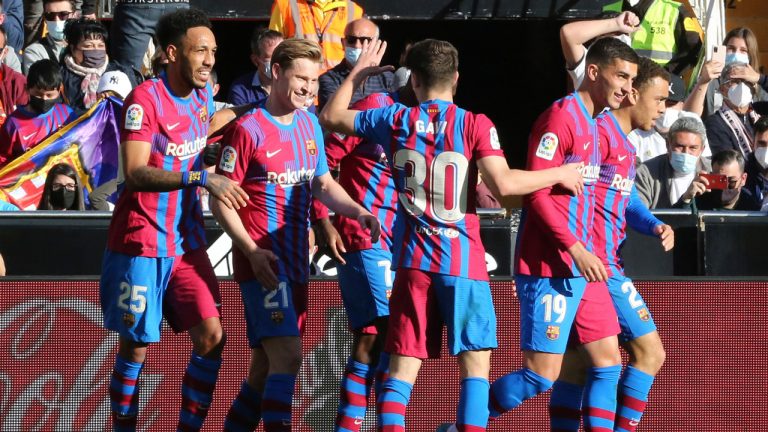 Barcelona's Pierre-Emerick Aubameyang, left, celebrates with team mates after scoring the opening goal during a Spanish La Liga soccer match between Valencia and Barcelona at the Mestalla stadium. (Alberto Saiz/AP)