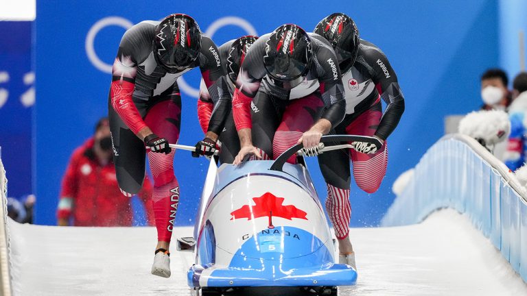 Justin Kripps, Ryan Sommer, Cam Stones and Benjamin Coakwell, of Canada, slide during the 4-man heat 1 at the 2022 Winter Olympics, Saturday, Feb. 19, 2022, in the Yanqing district of Beijing. (AP Photo/Dmitri Lovetsky)