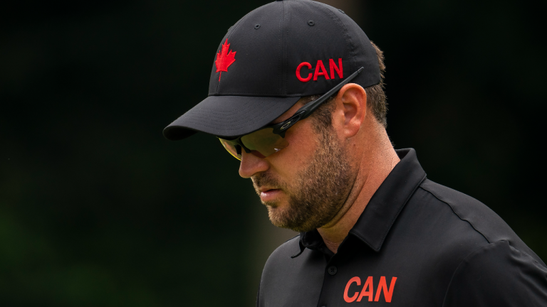 Canada's Corey Conners sports national logos as he walks to the fifth green in the men's individual golf event during the Tokyo Summer Olympic Games, in Saitama, Japan, Thursday, July 29, 2021. (CP/file)