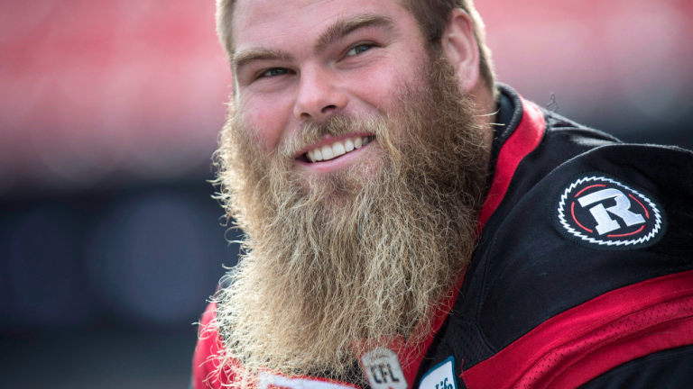 Ottawa Redblacks offensive lineman Jon Gott chats with teammates during the Eastern Conference practice, in Toronto on Saturday, November 26, 2016. The Ottawa Redblacks will play against the Calgary Stampeders Sunday in the 104th CFL Grey Cup. (CP/file)