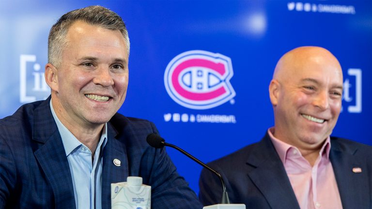 New Montreal Canadiens interim head coach Martin St. Louis, left, and general manager Kent Hughes laugh as they speak to reporters in Brossard, Que., Thursday, February, 10, 2022. (Graham Hughes/CP)