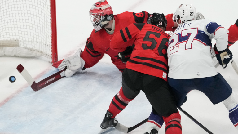 Team Canada goaltender Eddie Pasquale (80) lets in the second goal as Team Canada defender Maxim Noreau (56) and Team United States forward Noah Cates (27) look on during first period men’s ice hockey preliminary action Saturday, February 12, 2022 at the 2022 Winter Olympics in Beijing. THE CANADIAN PRESS/Ryan Remiorz