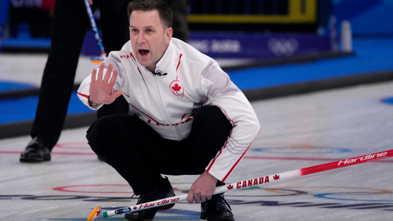 Canada's Brad Gushue directs his teammates during the men's curling match against the Russian Olympic Committee at the 2022 Winter Olympics, Tuesday, Feb. 15, 2022, in Beijing. (AP)