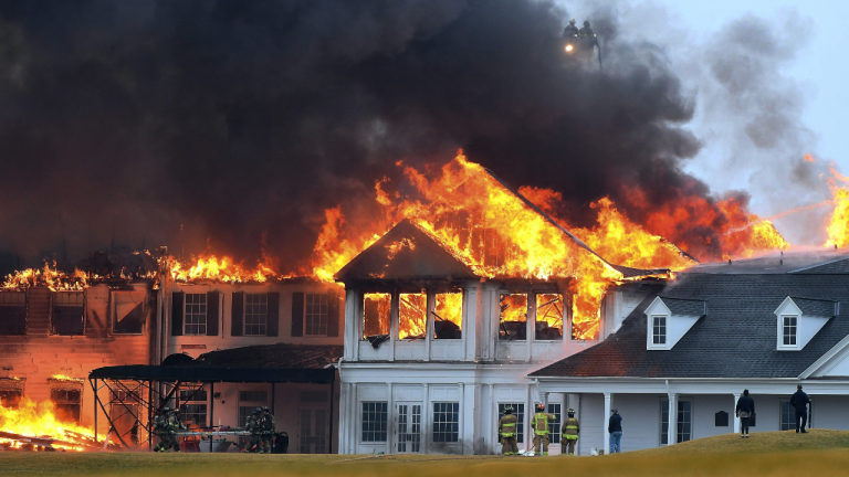 A fire burns at the main building at Oakland Hills Country Club in Bloomfield Township, Mich., on Thursday, Feb. 17, 2022. Firefighters battled a blaze at a more than century-old country club Thursday in suburban Detroit that's hosted several major golf tournaments and is one of Michigan's most exclusive golf clubs.(AP)