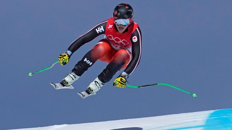 James Crawford, of Canada, makes a jump in the men's downhill at the 2022 Winter Olympics, Monday, Feb. 7, 2022, in the Yanqing district of Beijing. (Robert F. Bukaty/AP Photo)