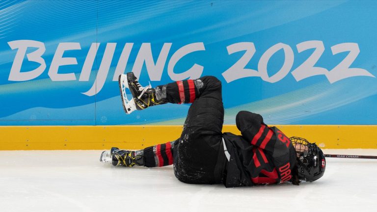Team Canada forward Melodie Daoust (15) lies on the ice after being injured during second period women’s ice hockey action against Switzerland Thursday, February 3, 2022 at the 2022 Winter Olympics in Beijing. (Ryan Remiorz/THE CANADIAN PRESS)