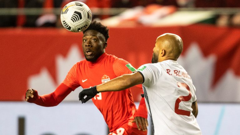 Team Canada's Alphonso Davies (19) and Costa Rica's Ricardo Jose Blanco Mora (2) vie for the ball during first half World Cup qualifier soccer action in Edmonton on Friday, November 12, 2021. (Jason Franson/AP)