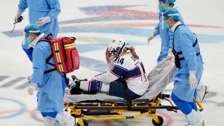 United States' Brianna Decker (14) is taken off the ice after being injured during a preliminary round women's hockey game against Finland at the 2022 Winter Olympics, Thursday, Feb. 3, 2022, in Beijing. (Petr David Josek/AP)