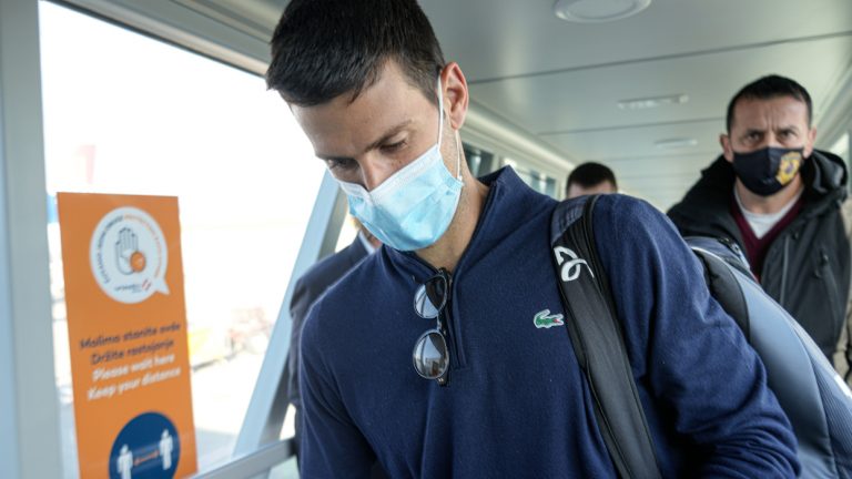 Novak Djokovic looks as his documents after landing in Belgrade, Serbia, Monday, Jan. 17, 2022. Djokovic arrived in the Serbian capital following his deportation from Australia on Sunday after losing a bid to stay in the country to defend his Australian Open title despite not being vaccinated against COVID-19.(Darko Bandic/AP)