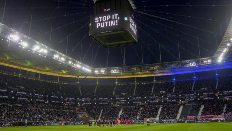 Teams pay a minute of silence for the people in Ukraine during a German Bundesliga soccer match between Eintracht Frankfurt and Bayern Munich in Frankfurt, Germany, Saturday, Feb. 26, 2022. (AP Photo/Michael Probst)