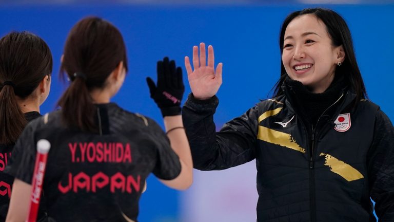 Japan's Satsuki Fujisawa encourages a teammate during a women's curling semifinal match between Japan and Switzerland at the Beijing Winter Olympics Friday, Feb. 18, 2022, in Beijing. (Brynn Anderson/AP Photo)