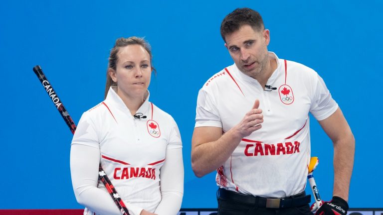Canada’s Rachel Homan and John Morris confer as they face Great Britain's Bruce Mouat and Jennifer Dodds in mixed doubles curling play at the 2022 Winter Olympics in Beijing on Thursday, February 3, 2022. (Paul Chiasson/THE CANADIAN PRESS)